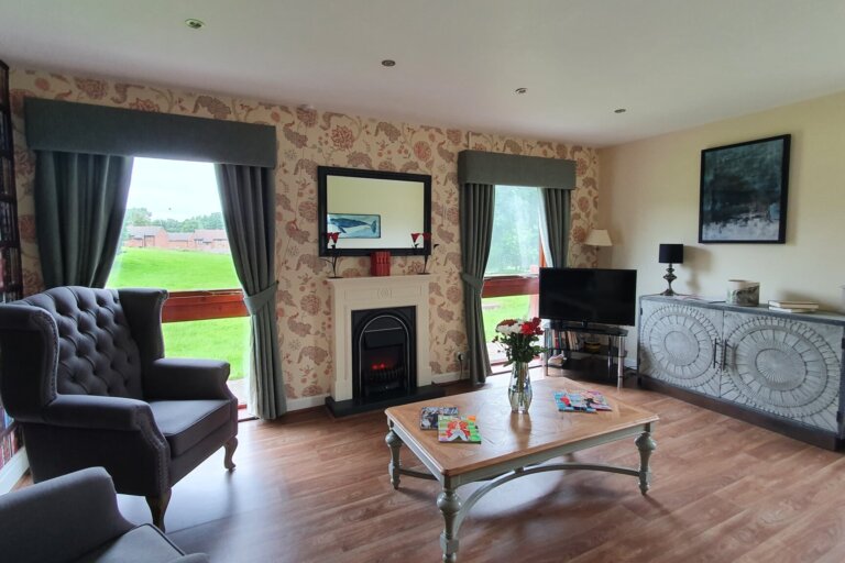 A quiet lounge at Maple Lodge with views into the garden