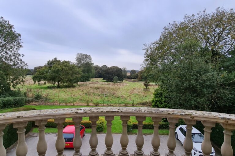 Enjoy the expansive view from upstairs at Oaktree Hall, capturing the lush surroundings and peaceful atmosphere of the care home.