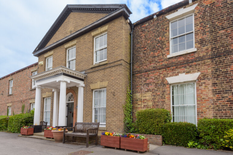 View the welcoming entrance of Figham House Care Home, inviting visitors into a warm and caring environment.