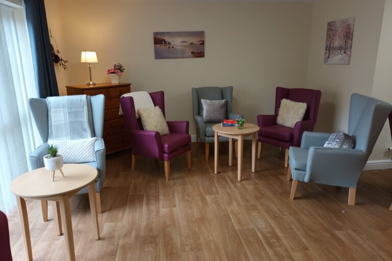 View of the cosy lounge at Alpine Lodge Care Home in Stocksbridge, a perfect spot for residents to relax, watch the day unfold, or enjoy conversations with friends and loved ones.