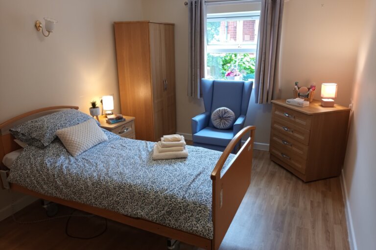 Image of a comfortably furnished bedroom at Alpine Lodge Care Home in Stocksbridge, designed for relaxation and privacy.